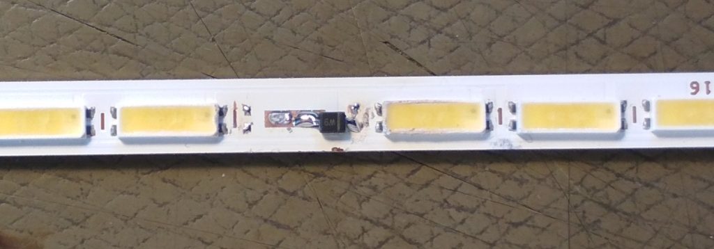 A thin PCB with LEDs
one LED has been replaced with a smol zener diode.